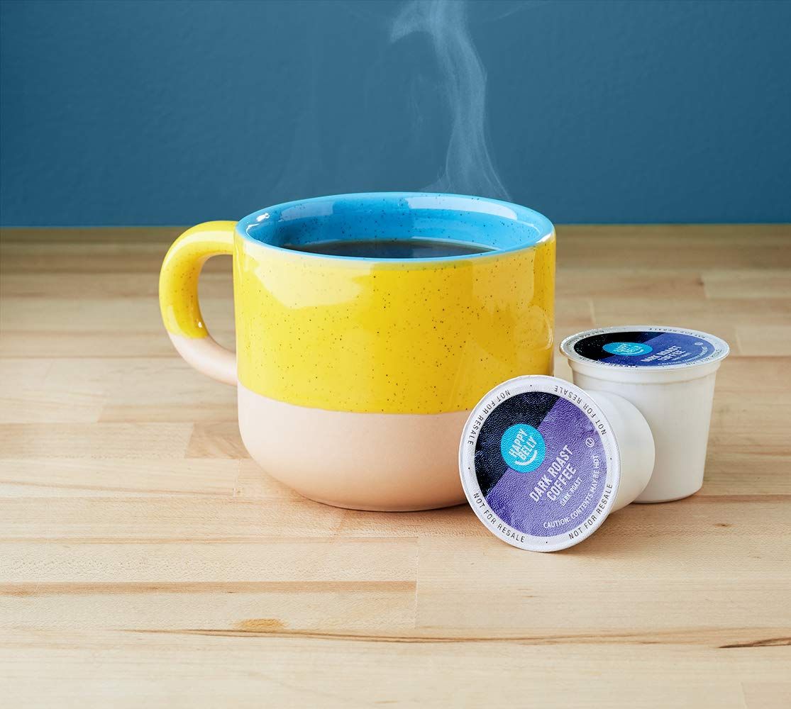 Shows the product in a real-world setting with a steaming mug to demonstrate how the coffee pods are used and create an appealing lifestyle context.