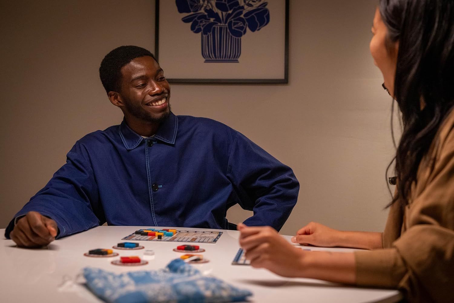 Demonstrates the product being enjoyed in a real-world social setting, showing two people engaged and happy while playing together, which communicates the…