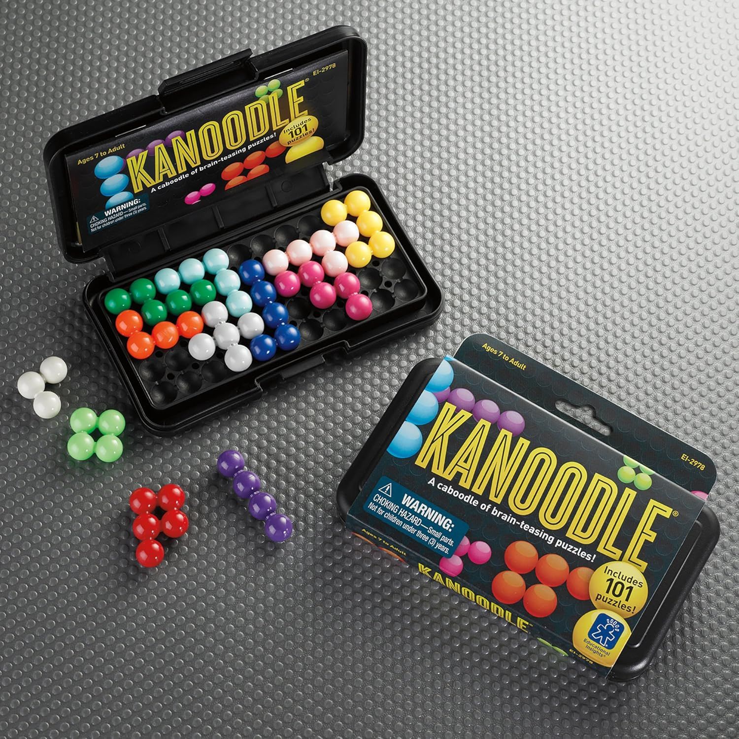 Shows everything included in the package—the puzzle pieces in multiple colors, the storage case, and the puzzle booklet—to help shoppers understand the…
