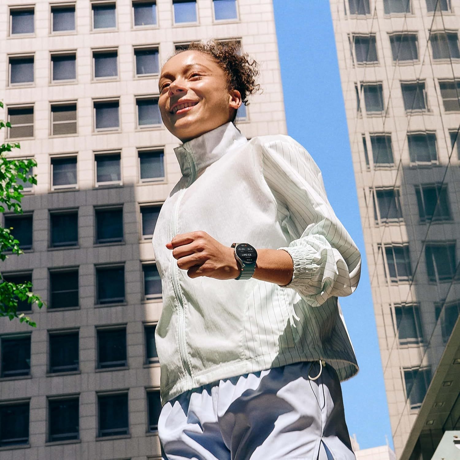 Demonstrates the product (smartwatch) in a real-world active lifestyle context, showing it being worn during outdoor exercise in an urban environment to help…