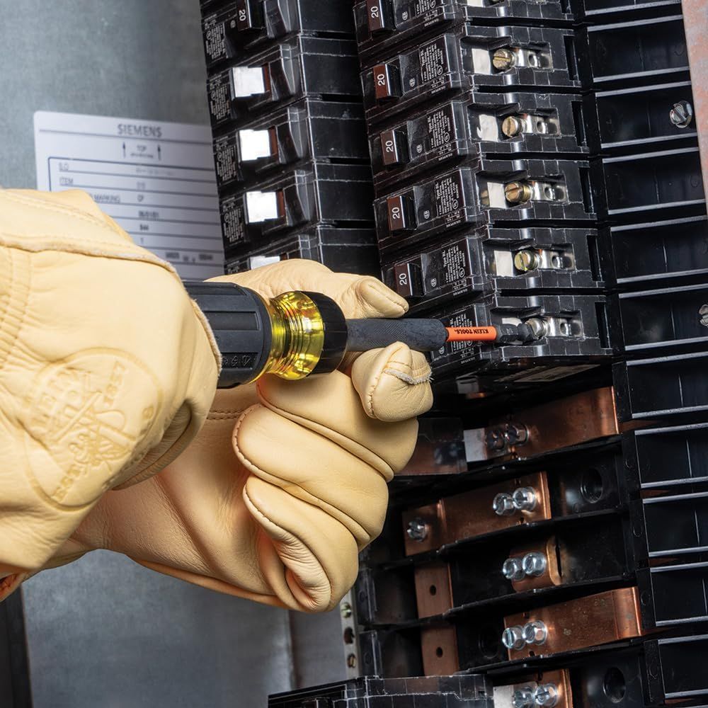 Demonstrates how to properly use the screwdriver tool with the circuit breaker panel, showing shoppers the correct installation or maintenance technique for electrical work. Shows the product in a…