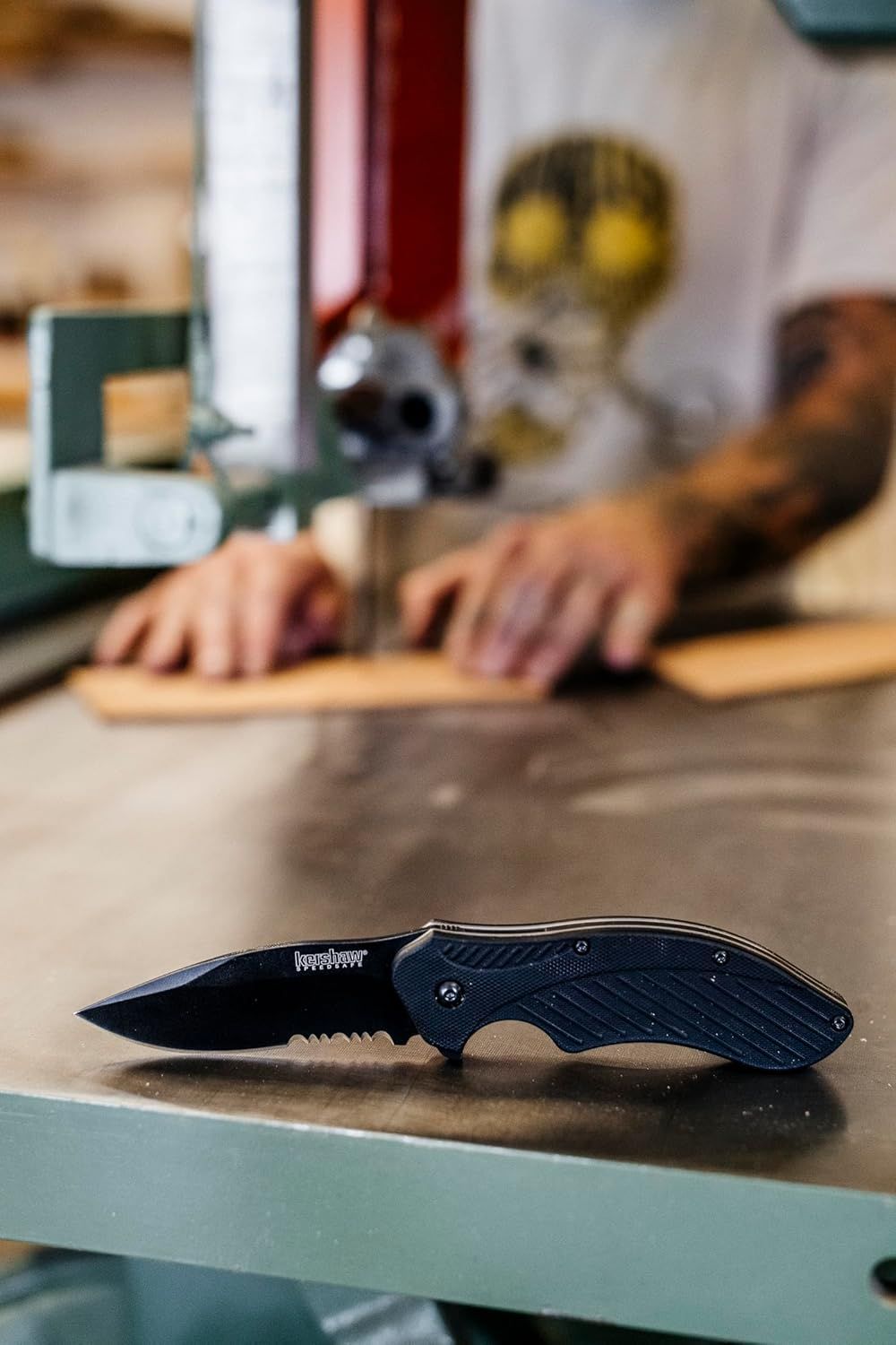 Shows the product in an authentic workshop or home environment to help shoppers visualize the knife as a practical everyday tool.