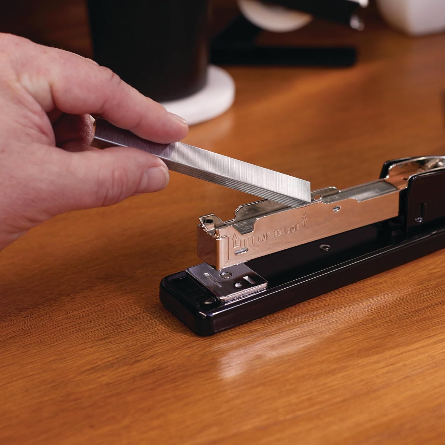 Demonstrates how to load staples into the stapler, showing the ease of use and simple refill process to reassure shoppers about maintenance. Highlights the straightforward staple-loading mechanism…