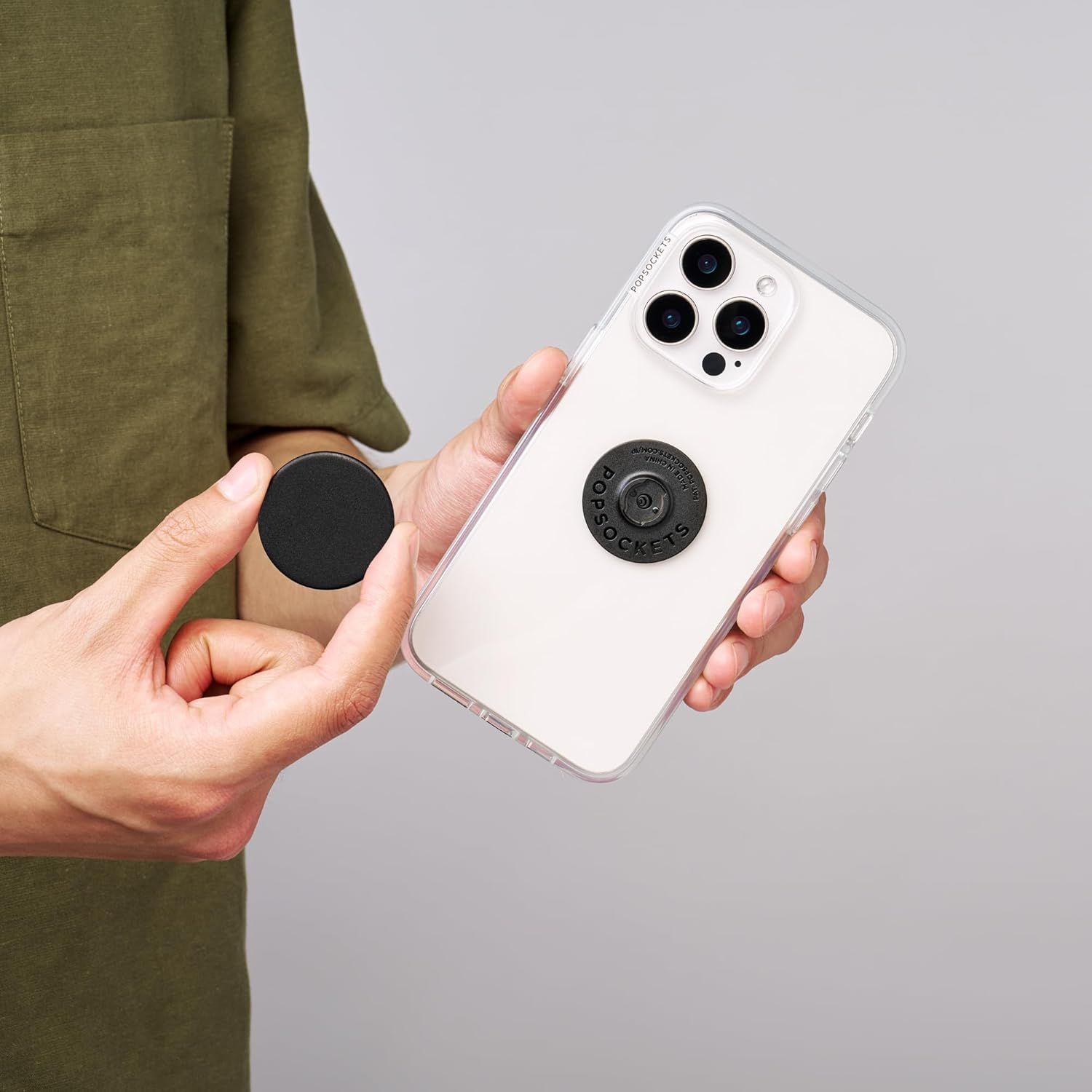 Demonstrates the product's swappable, customizable design feature, showing how users can easily remove and replace the PopSocket accessory to personalize their phone case.