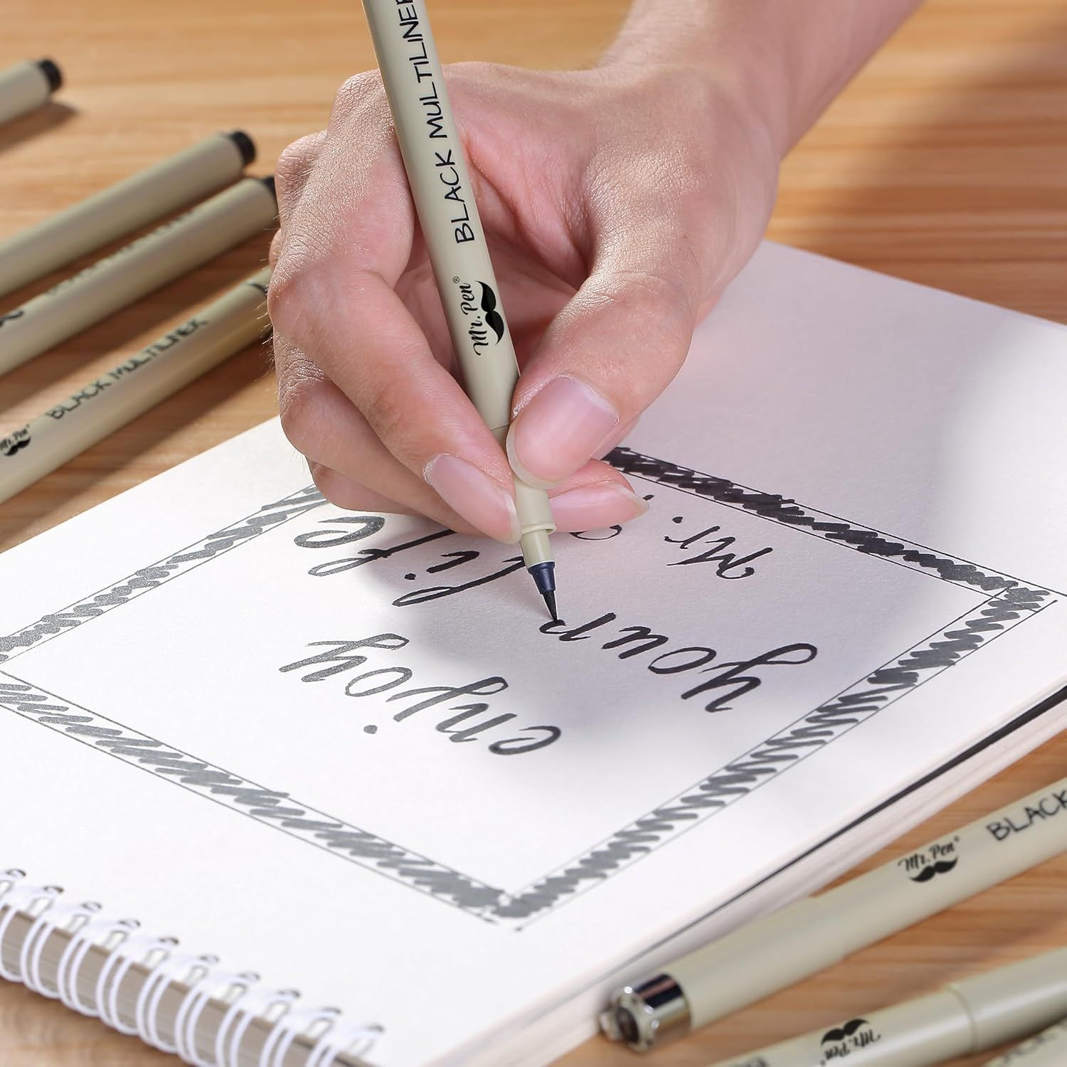 Demonstrates the product being used in a real-world creative context to show shoppers how the pen performs for hand lettering and calligraphy work.