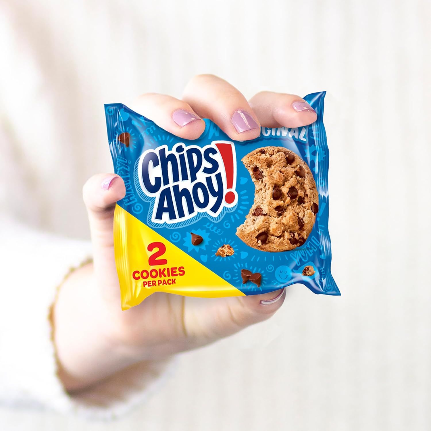 Shows authentic, relatable customer usage of the product in a real-world setting to build trust and demonstrate portability. Highlights the convenient portion-controlled packaging with 2 cookies per…