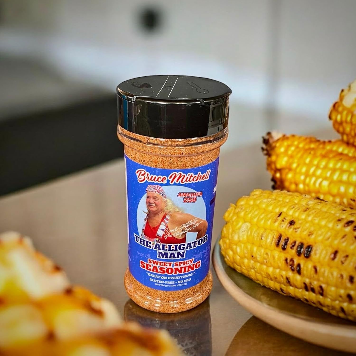 Shows the product in an authentic home setting with prepared food to help shoppers visualize how they would use the seasoning in their own cooking.