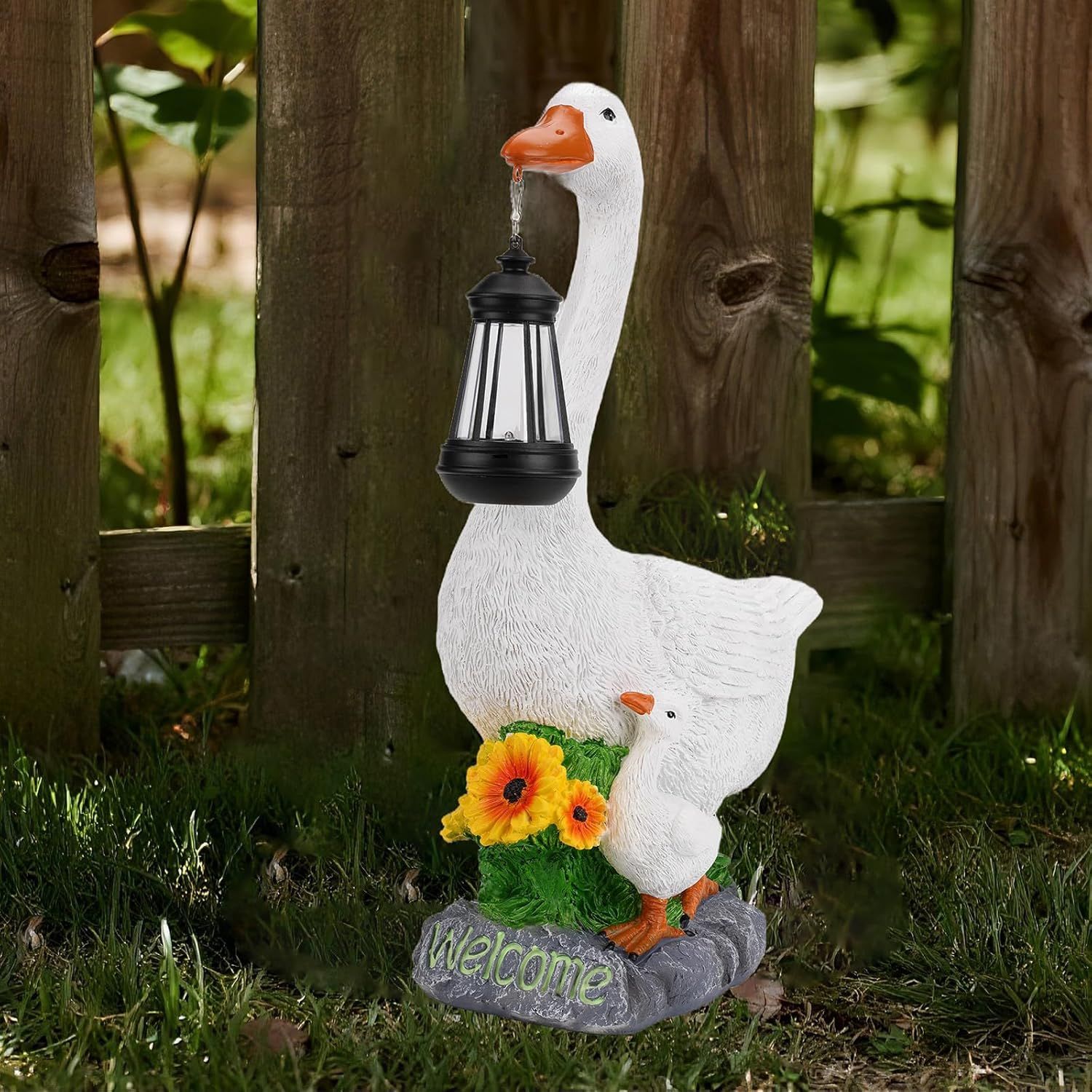 Displays the complete product—a decorative goose statue holding a lantern—in a real-world outdoor setting to show shoppers what they will receive and how it looks in use.
