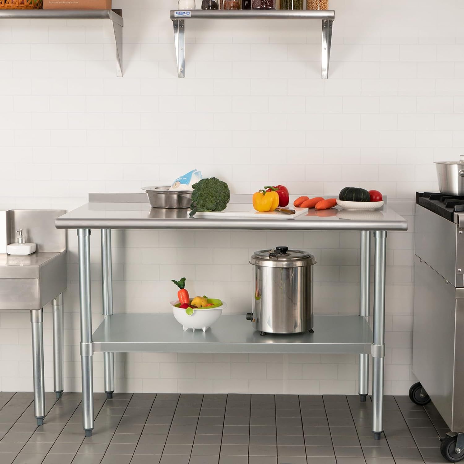 Demonstrates the product in a real-world kitchen setting to help shoppers visualize how the stainless steel work table fits into their cooking space and workflow.