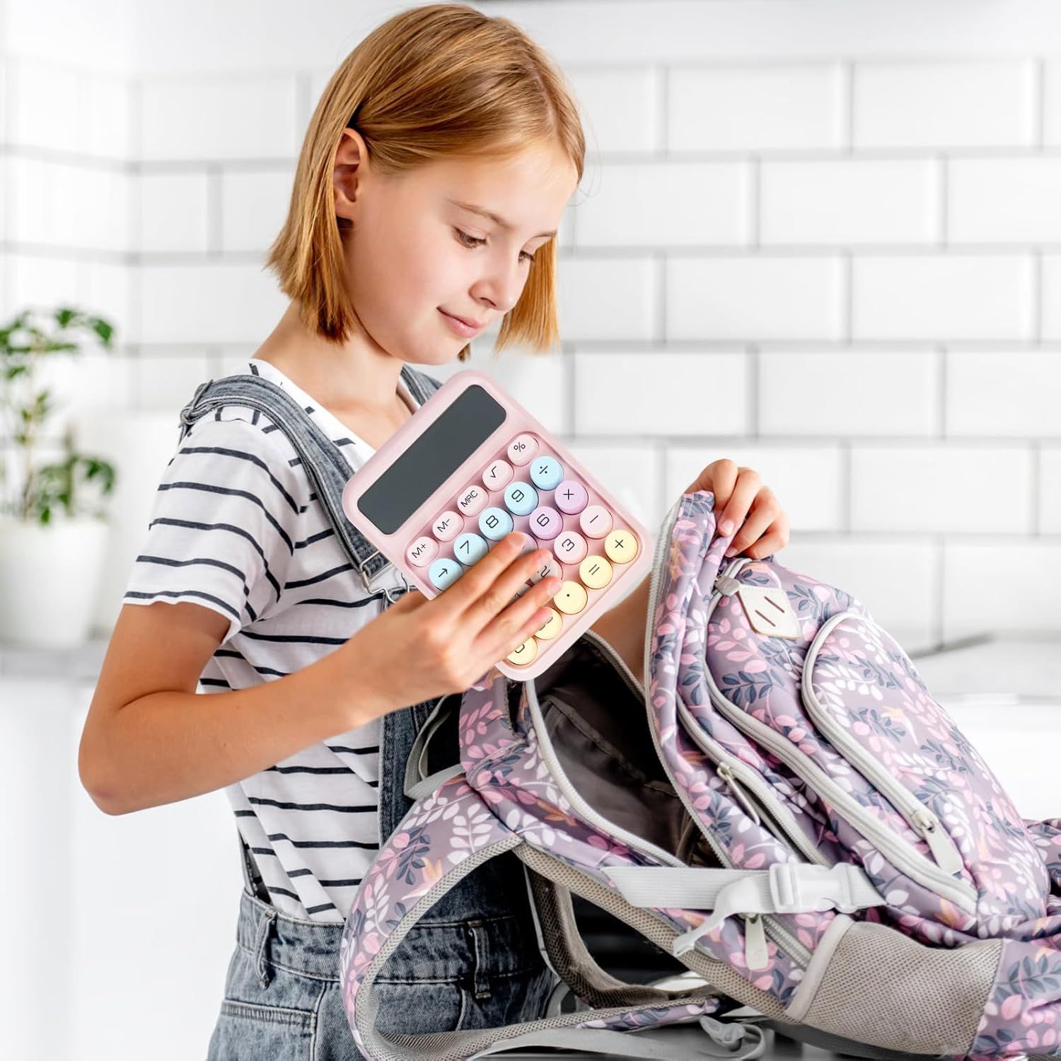 Demonstrates the product in a real-world context showing a child using the calculator with their school backpack, communicating that the product is practical…