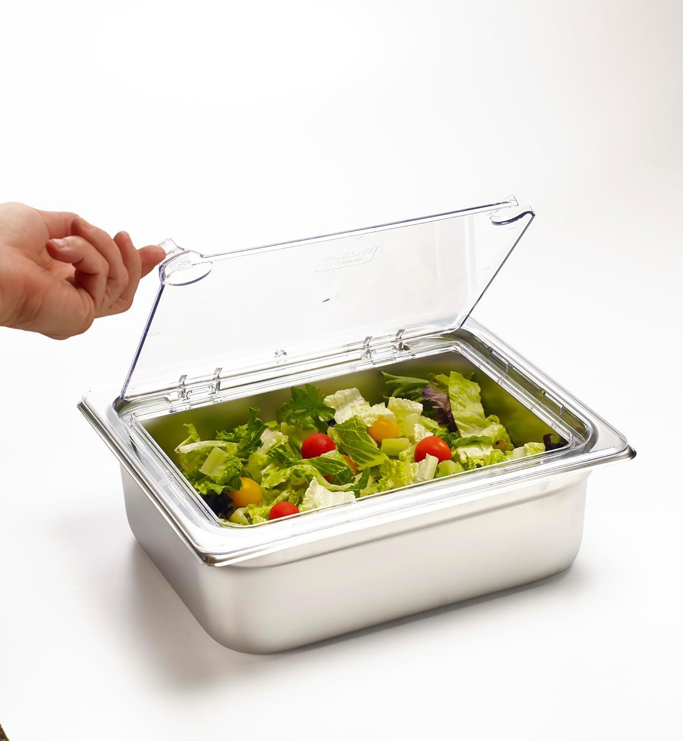 Demonstrates the product in a real-world kitchen setting, showing how the container holds fresh salad with its clear hinged lid, helping shoppers visualize practical everyday use.