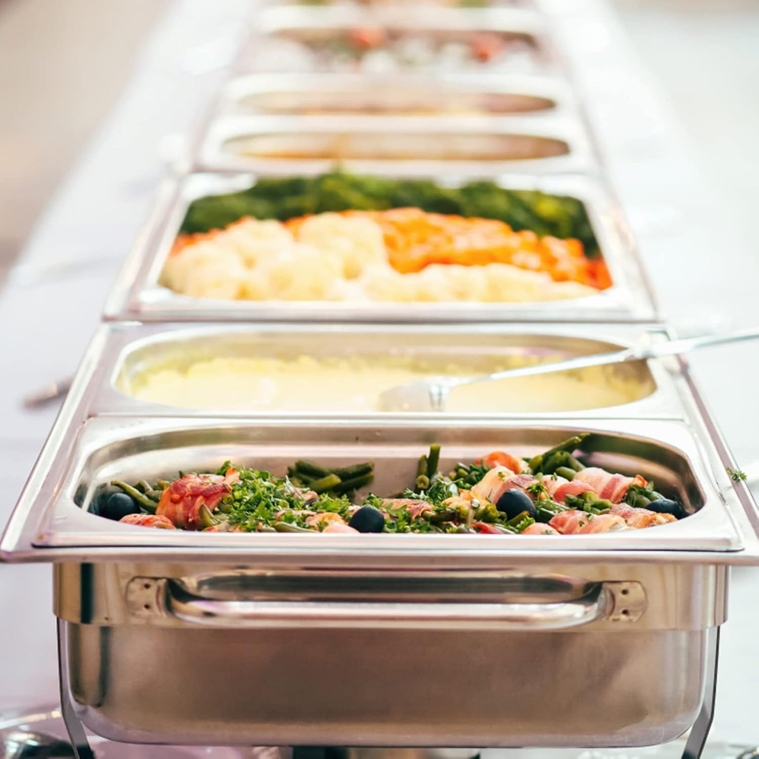 Demonstrates the product in a real-world catering or food service setting, showing how the chafing dish/food warmer holds and presents multiple dishes…