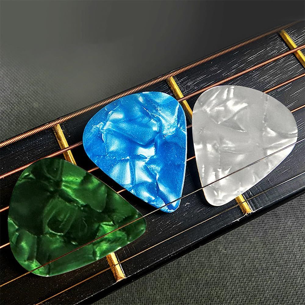 Shows the variety of colorful guitar picks included with the product, demonstrating what the customer receives and the aesthetic options available.