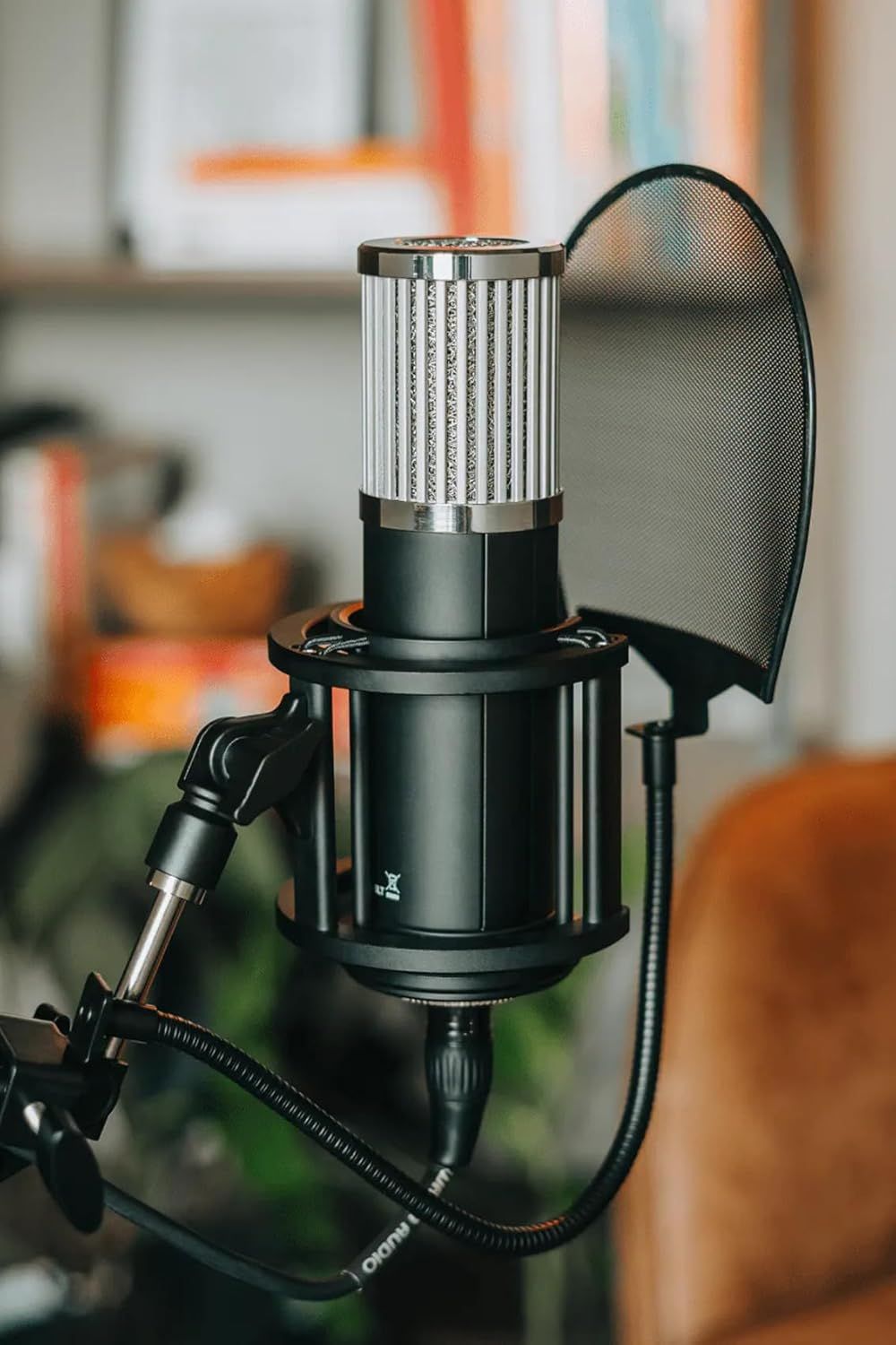 Showcases the microphone in a real-world home or studio environment to help shoppers visualize the product in use and understand its professional quality and aesthetic appeal.