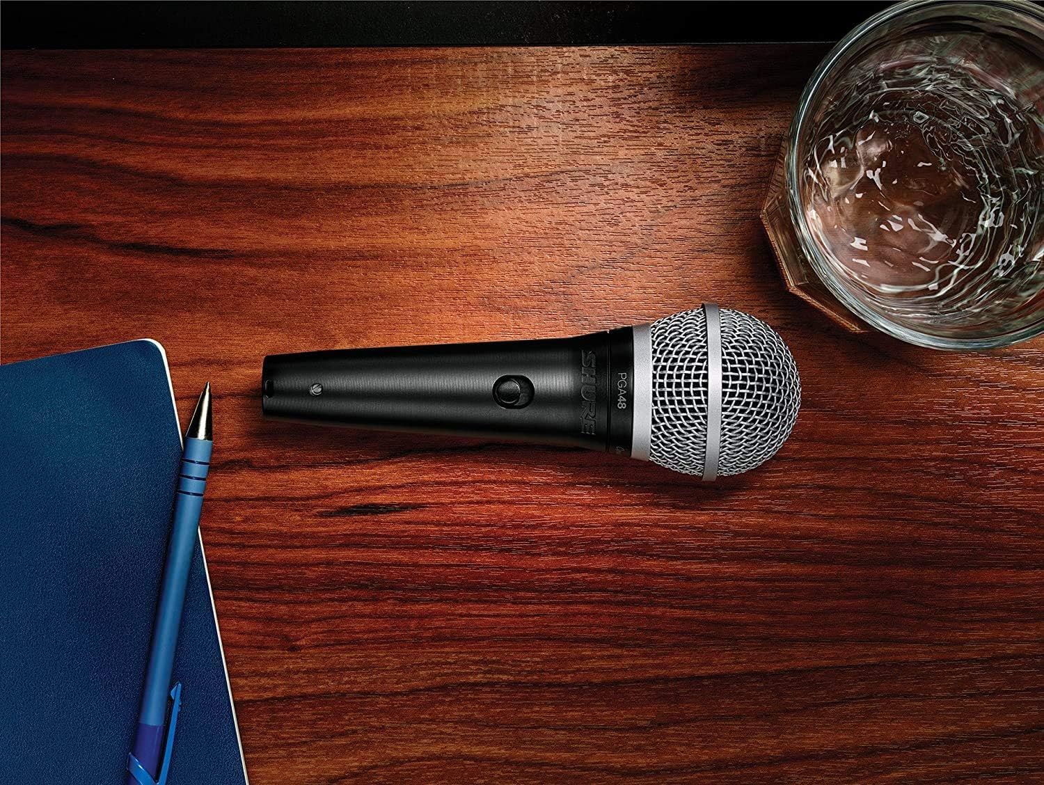 Showcases the microphone in a real-world professional context to help shoppers visualize the product in use during presentations, meetings, or creative work.