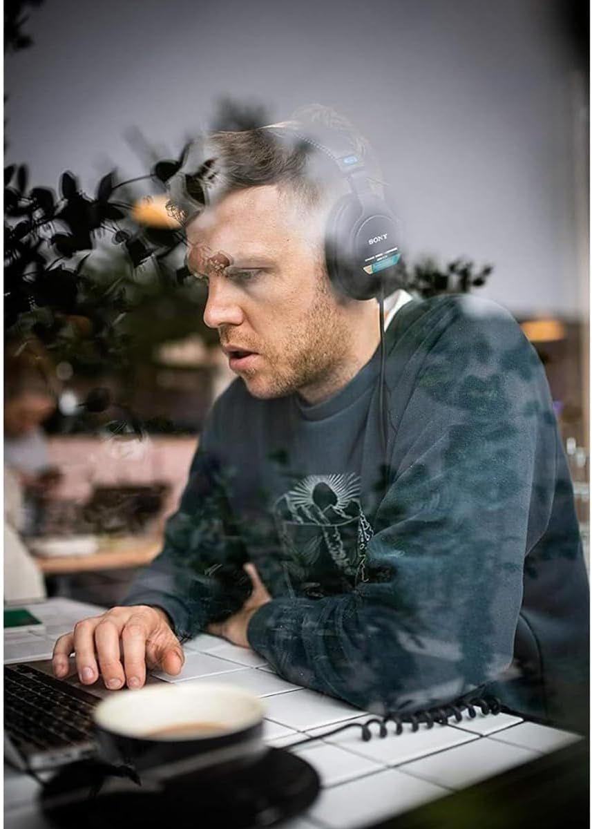 Shows the product (Sony headphones) being used in an authentic work setting to help shoppers visualize how the product fits into their daily life and work…