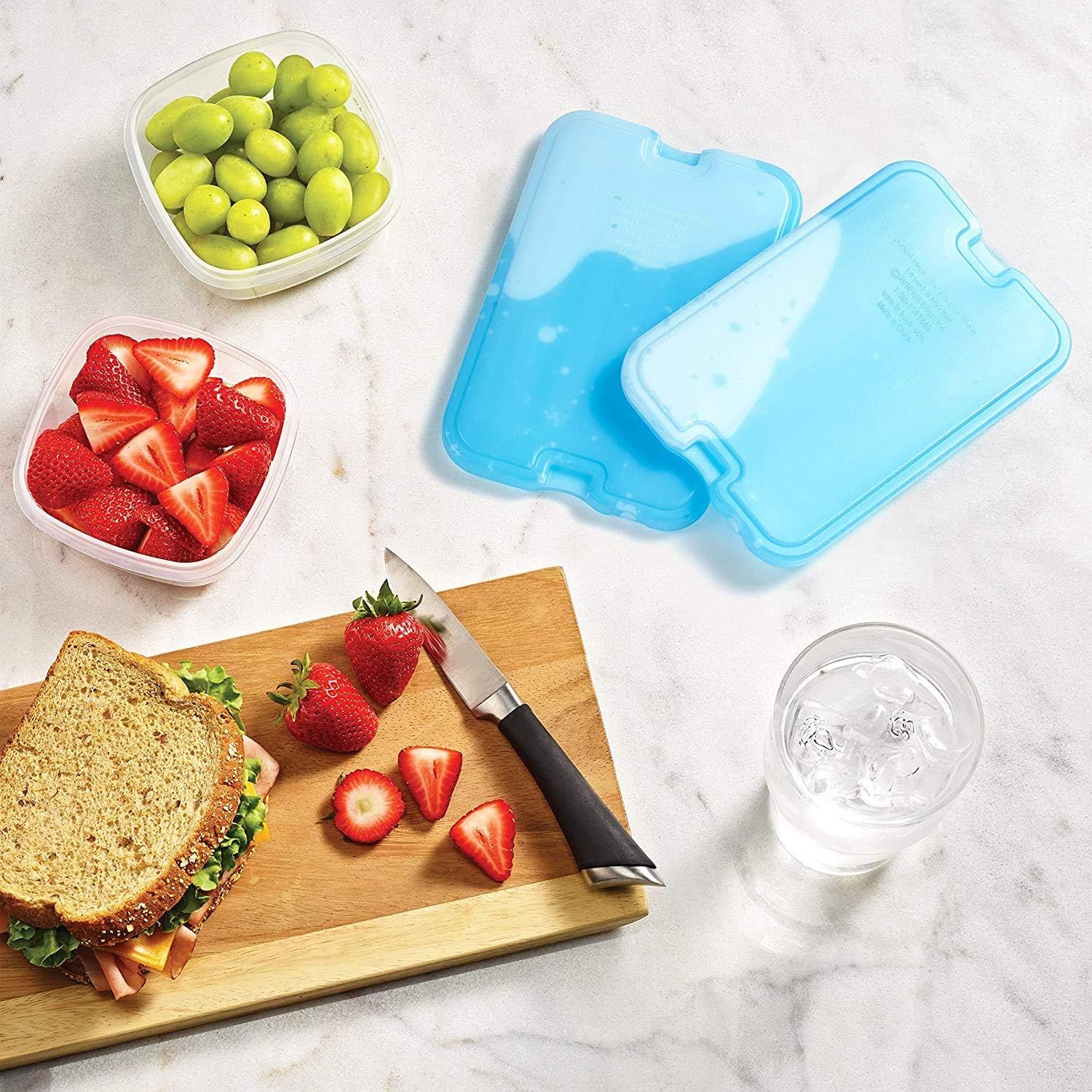 Demonstrates the product in a real-world lunch preparation context, showing how the containers fit into everyday meal planning and food storage routines.