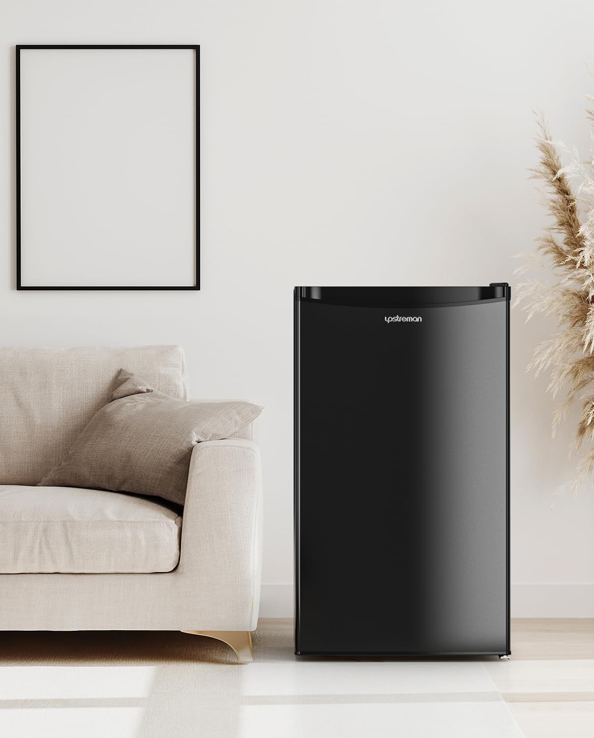 Shows the mini fridge in a real-world living room setting to help shoppers visualize how the compact appliance fits naturally into their home decor and lifestyle.