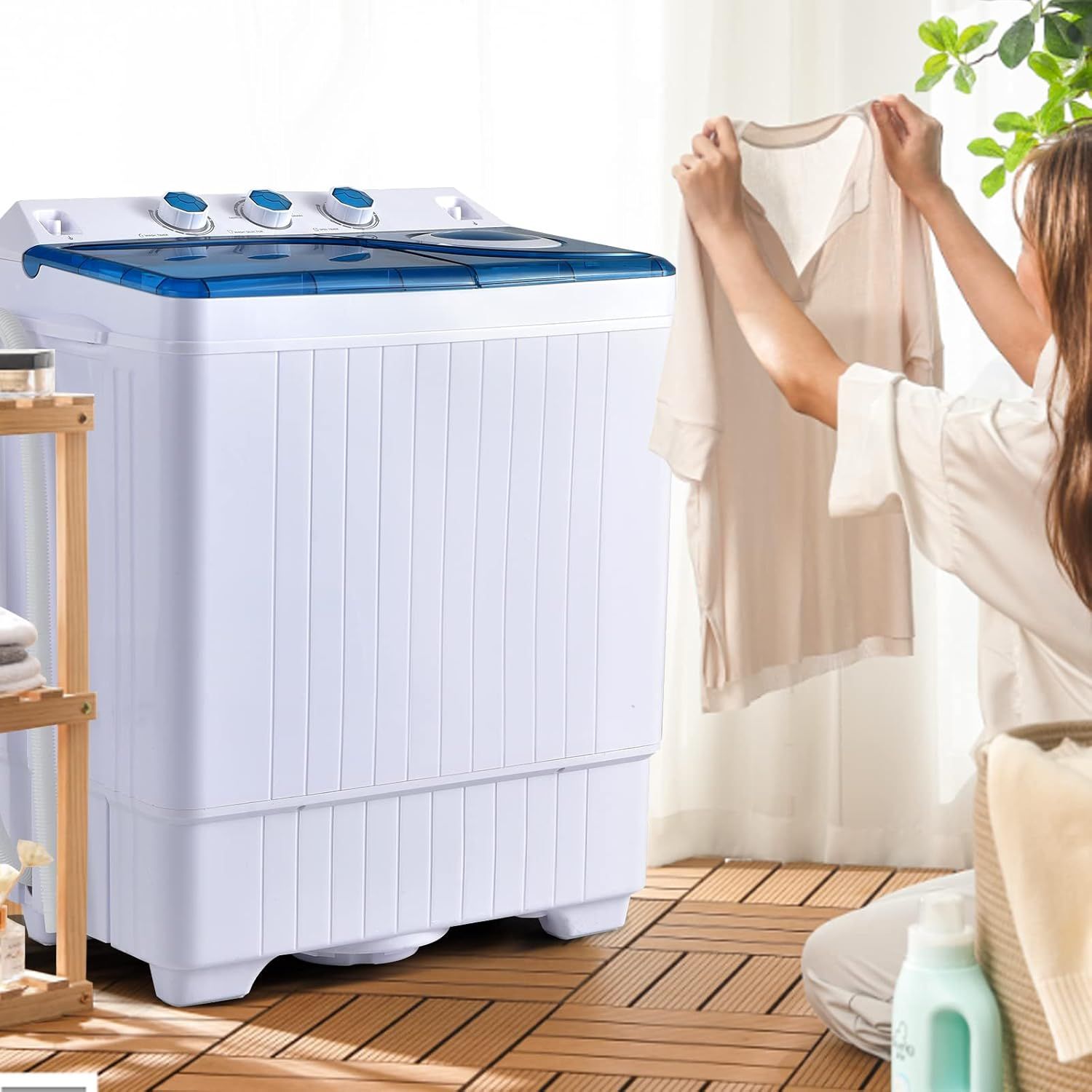 Shows the portable washing machine in a real-world home setting to help shoppers visualize how the product fits into their daily laundry routine.