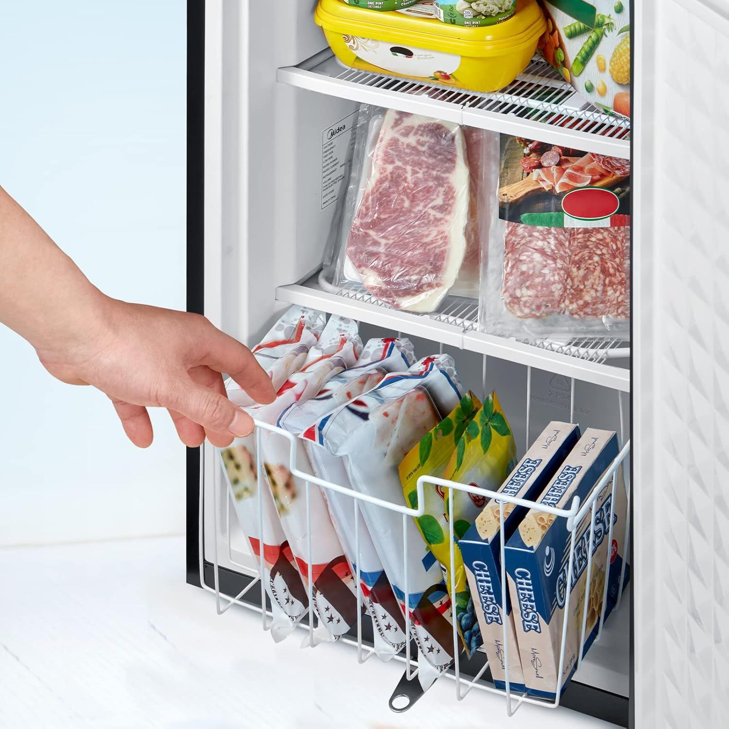 Demonstrates the convenient pull-out basket feature that helps organize frozen foods and makes items easily accessible in the freezer.