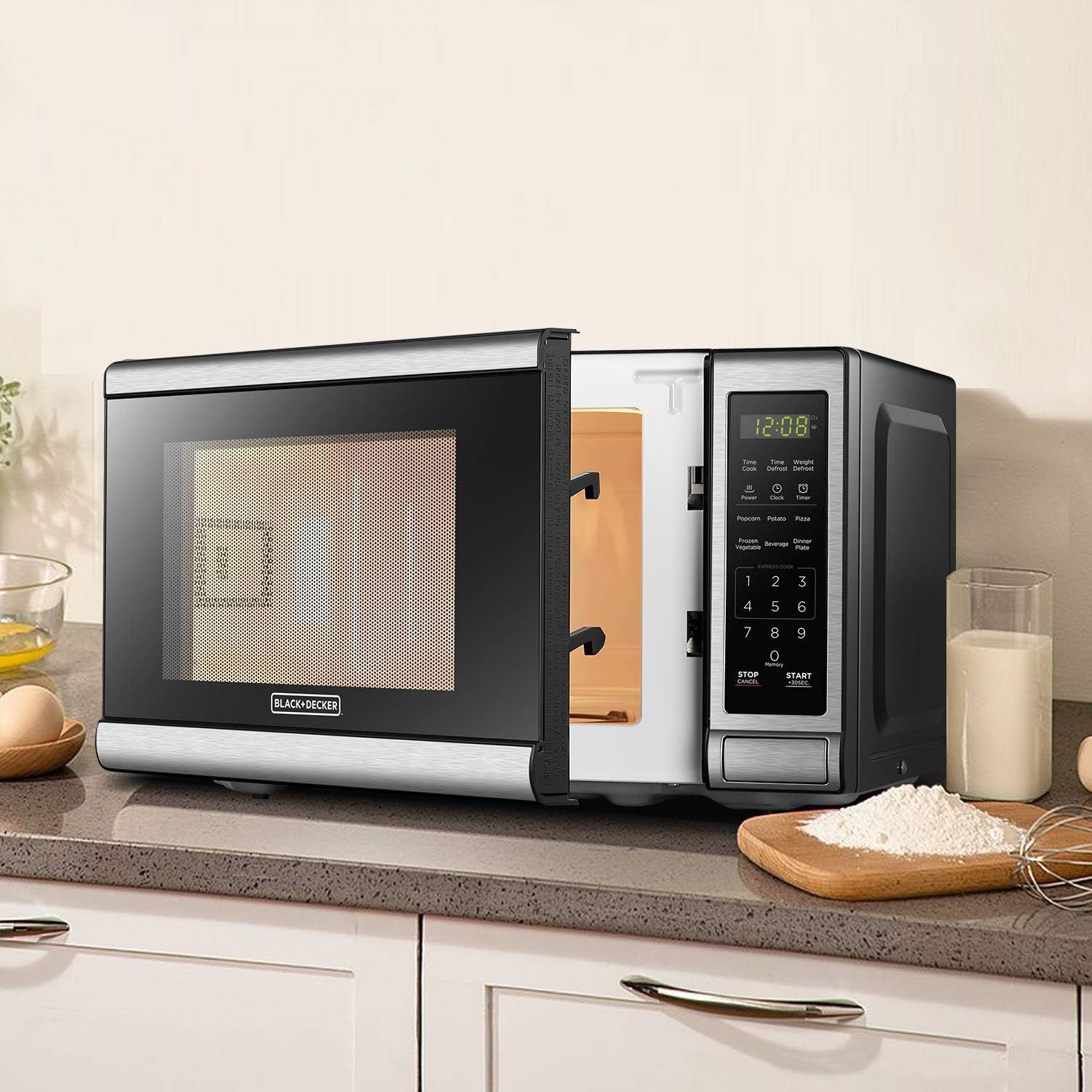 Shows the microwave in a real kitchen setting to help shoppers visualize how the product looks and fits in their home environment.