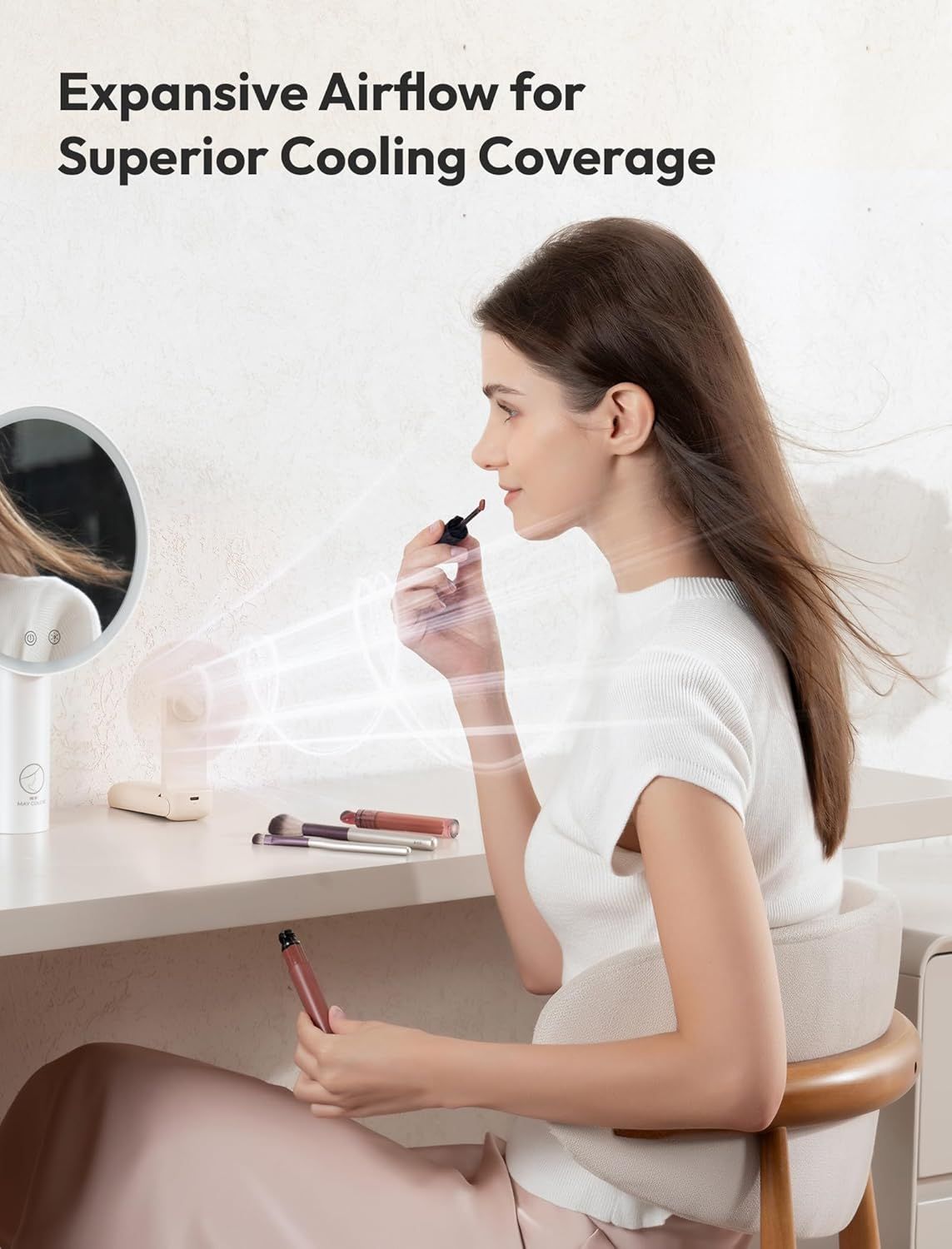 Demonstrates the fan's powerful airflow capability by showing how it effectively cools the user while applying makeup, emphasizing wide cooling coverage and…