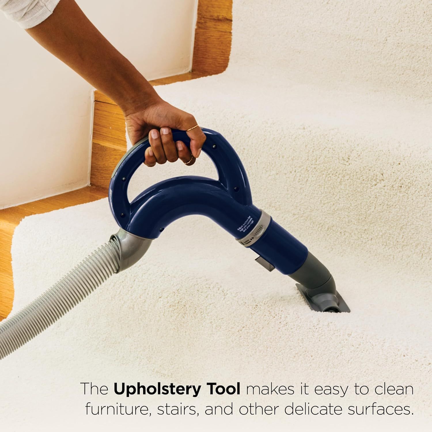 Demonstrates the upholstery tool attachment in use to show shoppers how easily the vacuum can clean furniture, stairs, and delicate surfaces.