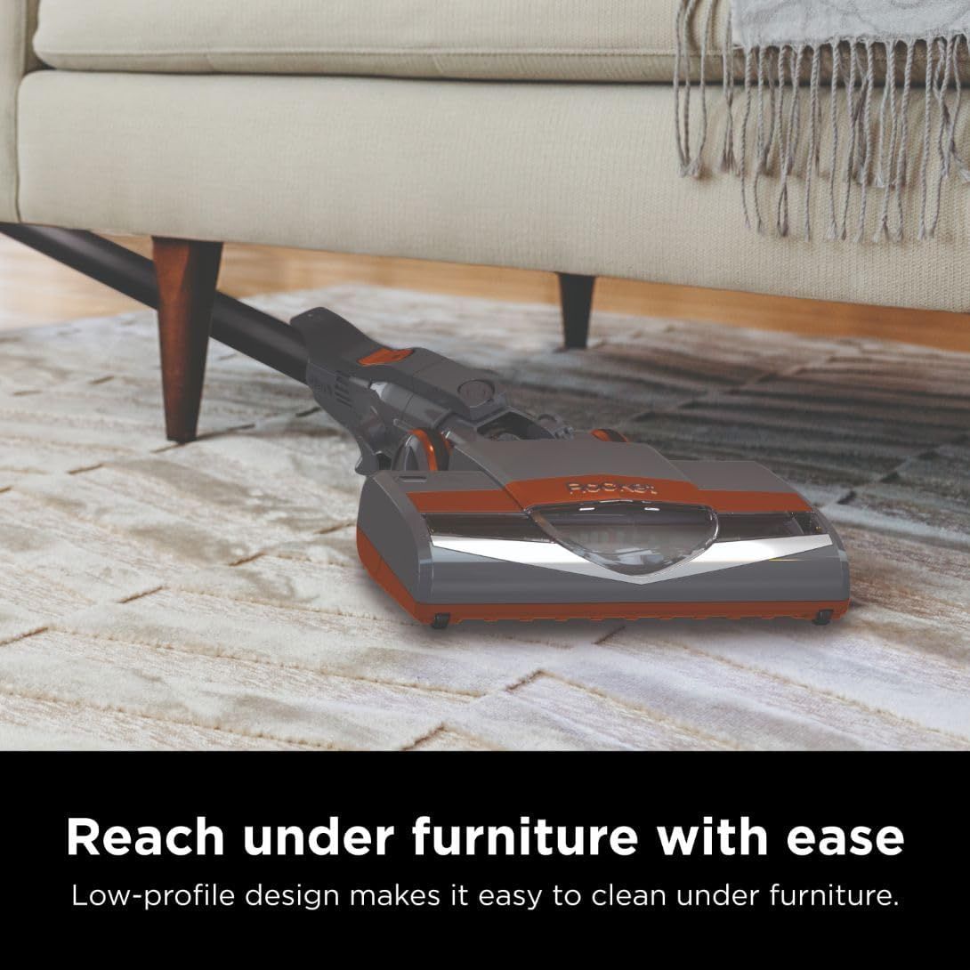 Demonstrates that the vacuum's low-profile design allows it to easily reach and clean under furniture, solving a common cleaning pain point.