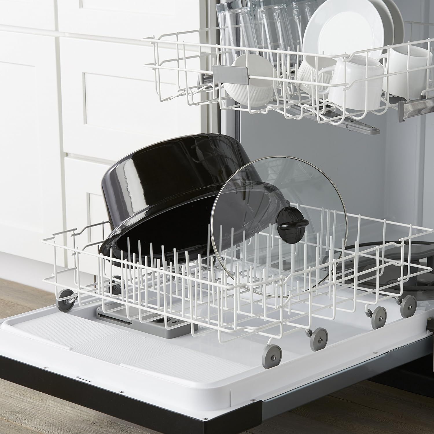 Demonstrates the product in a real-world kitchen context, showing pots and pans loaded in a dishwasher to communicate ease of cleaning and dishwasher…