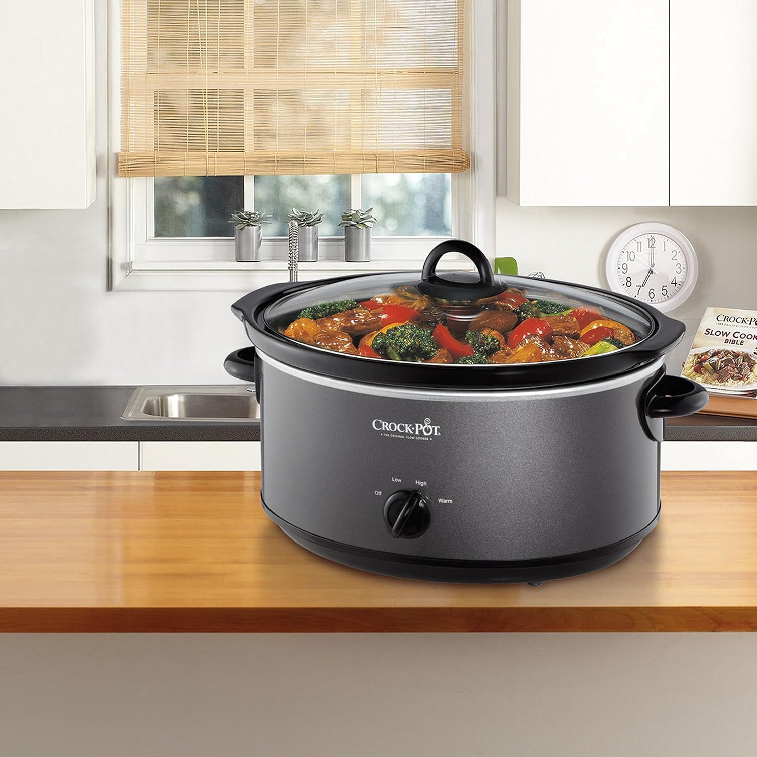 Shows the Crock-Pot slow cooker in a real kitchen environment with prepared food inside, helping shoppers visualize the product in their own home and see the…