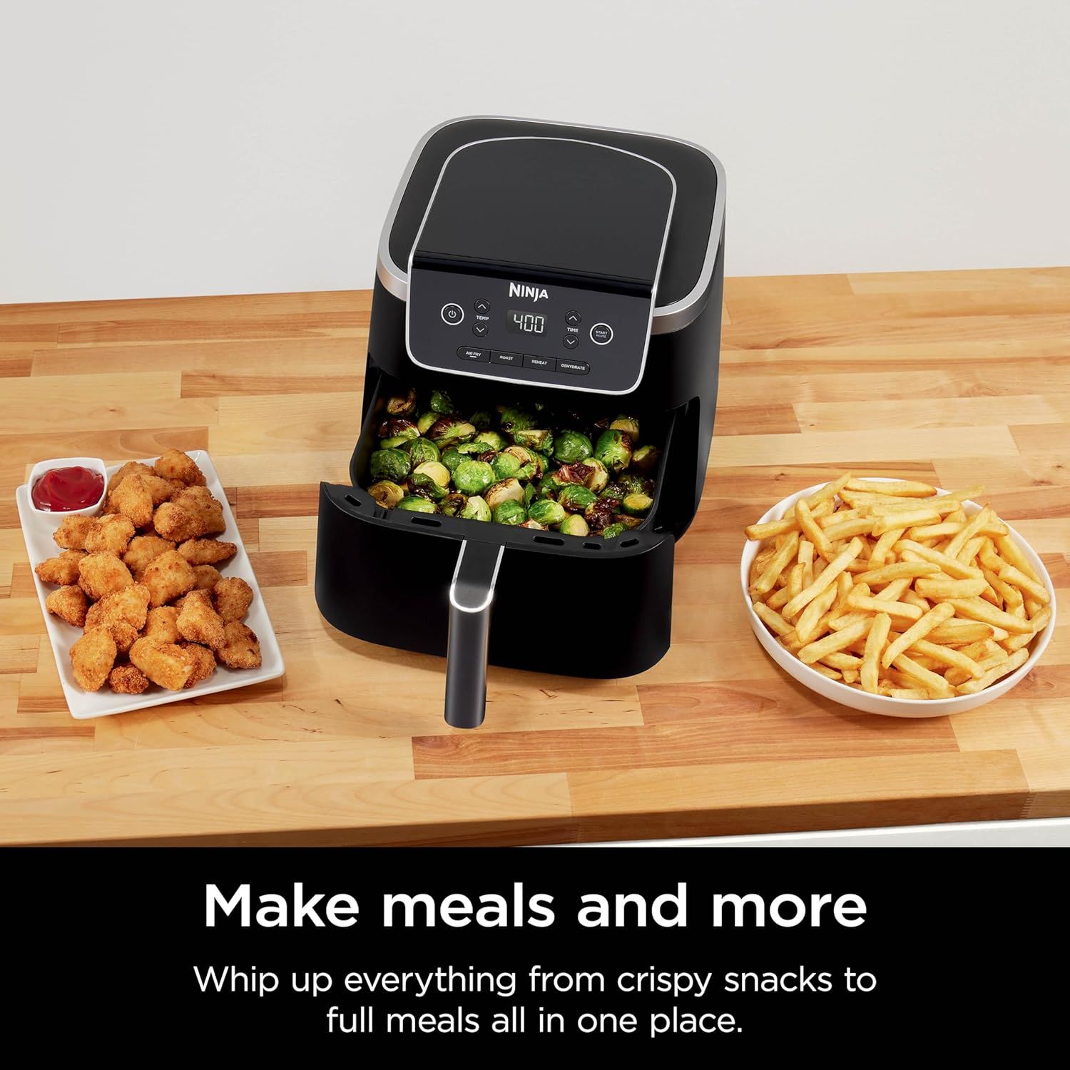 Demonstrates the air fryer's versatility by showing it can prepare multiple types of food (chicken nuggets, Brussels sprouts, and French fries), reassuring…