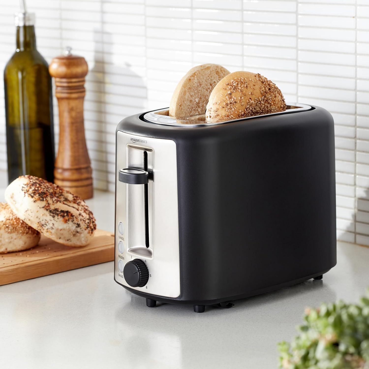 Shows the toaster in a real-world kitchen setting with bagels being toasted, helping shoppers visualize the product in their own home and understand its…
