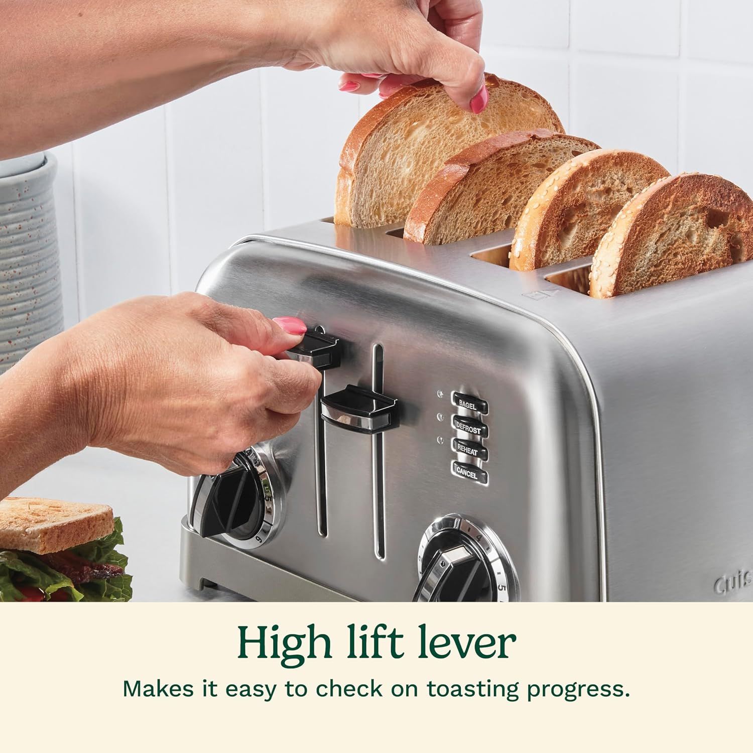 Highlights the high lift lever feature that allows users to easily check on toasting progress and safely remove bread without burning their fingers.