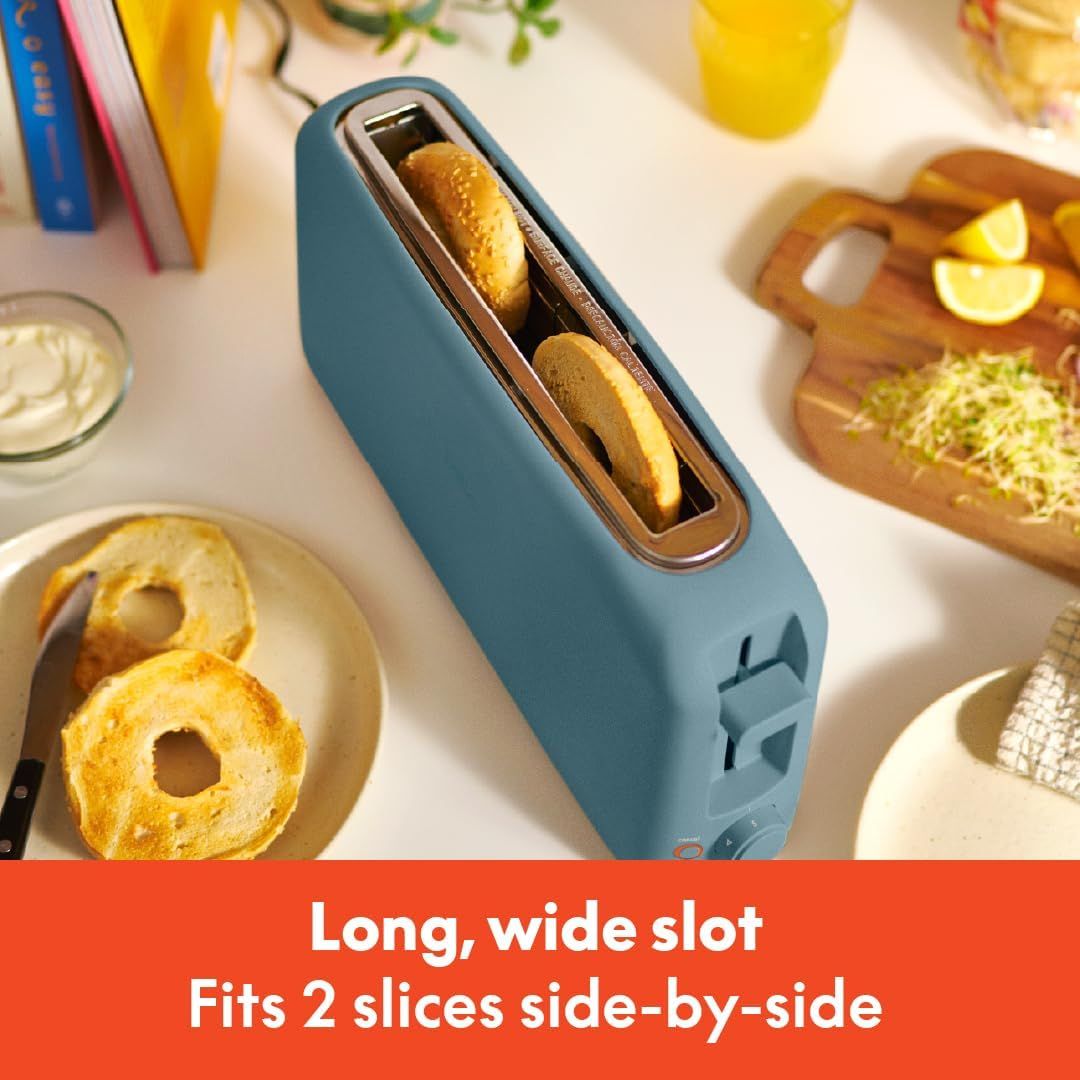 Communicates that the toaster has a long, wide slot that can accommodate two slices of bread side-by-side, emphasizing convenience and capacity for larger or…