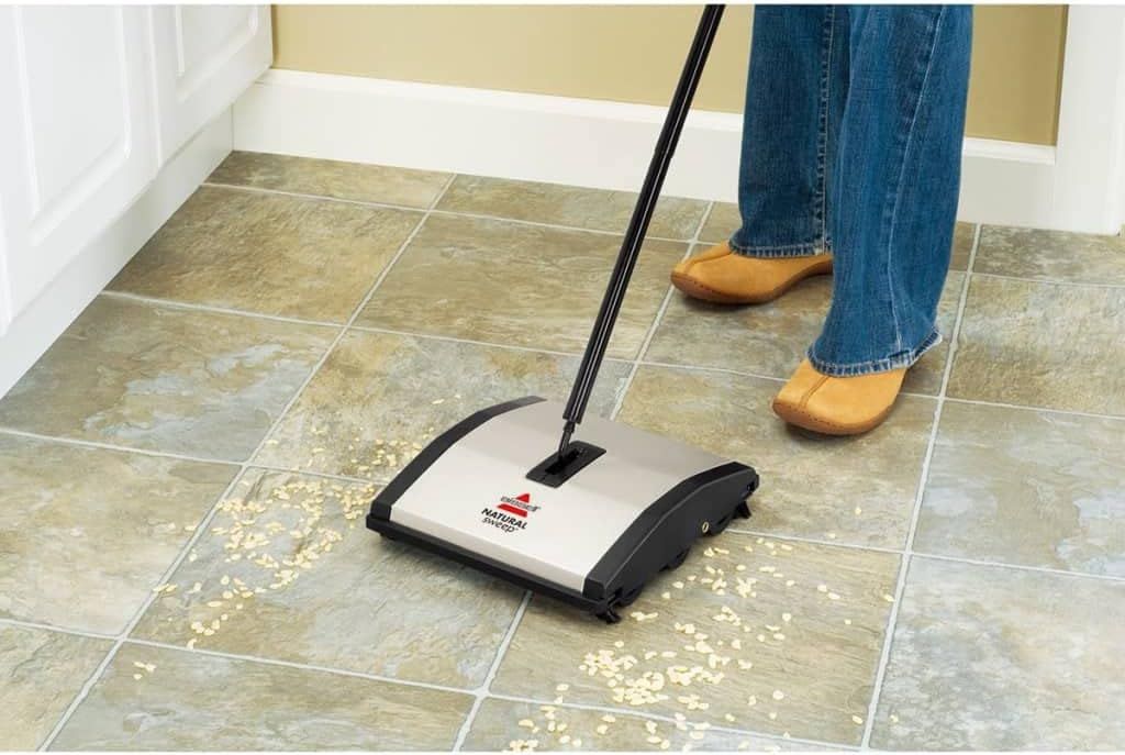 Shows the product being used in a real home environment to help shoppers visualize how the sweeper works on tile floors with debris, demonstrating its…