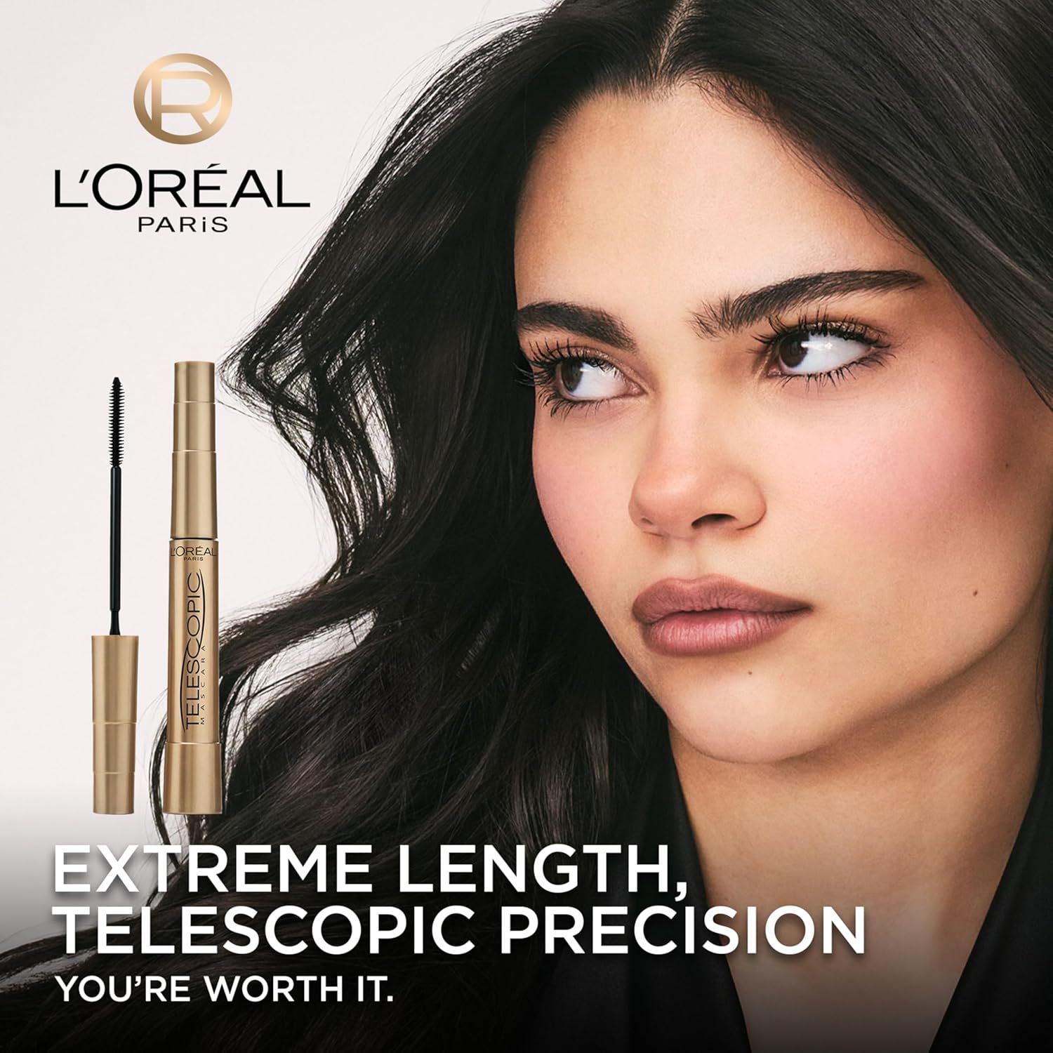 This image establishes L'Oréal Paris brand identity and emotional connection with the tagline 'YOU'RE WORTH IT,' while showcasing the Telescopic mascara…