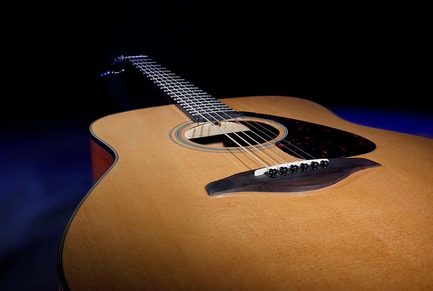 Showcases the acoustic guitar in an artistic, professional setting to emphasize its craftsmanship and appeal to musicians seeking quality instruments.
