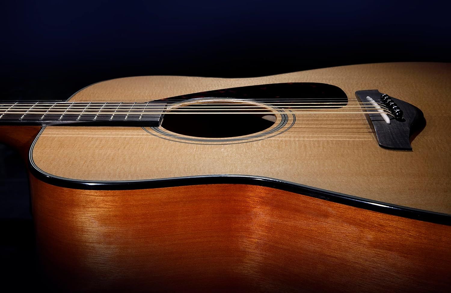 Displays the acoustic guitar in a clean, professional manner to showcase its natural wood finish, craftsmanship, and overall design without distractions.