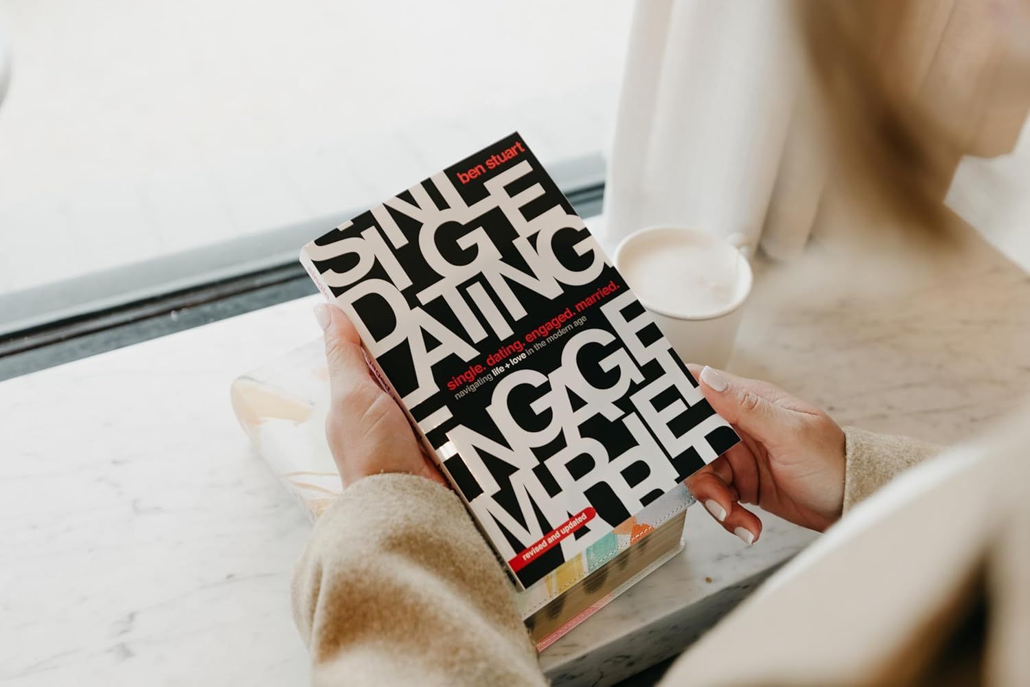 Demonstrates the product being used in a real-world relaxation setting to help shoppers visualize the book as part of their daily routine.