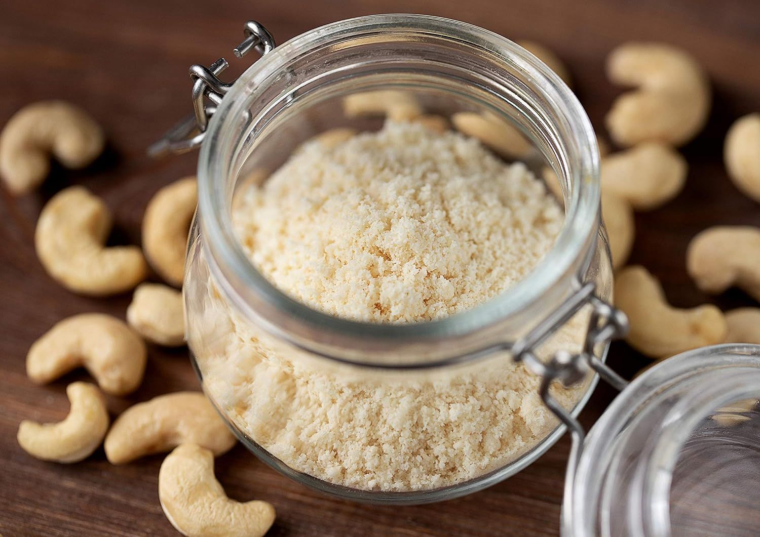 Shows the product (cashew flour or ground cashews) in an attractive, natural setting with whole cashews to communicate freshness and quality in a real-world…