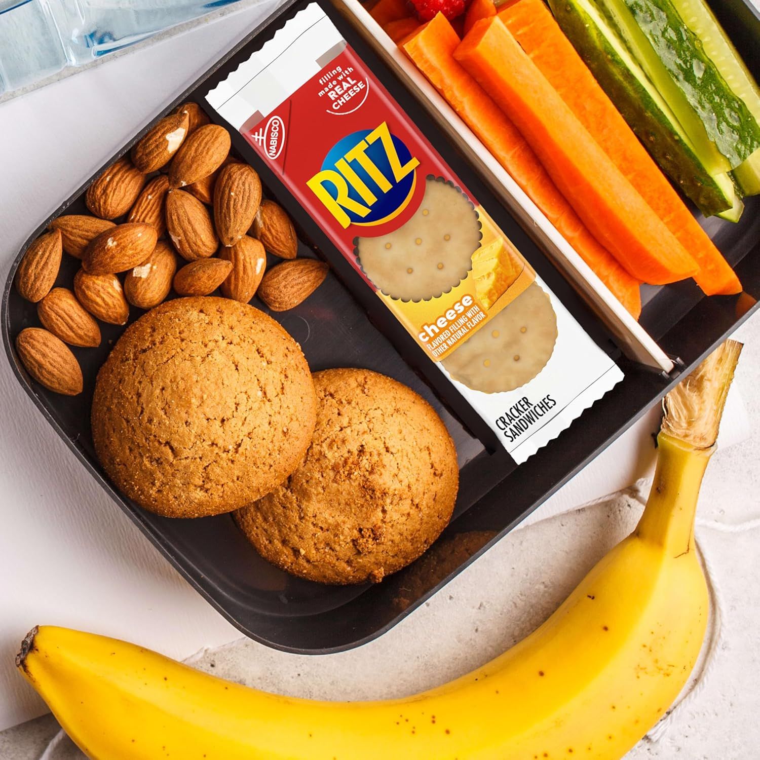Demonstrates multiple ways to enjoy Ritz crackers by showing them paired with various healthy snack options like almonds, cookies, vegetables, and fruit, positioning the product as versatile for…