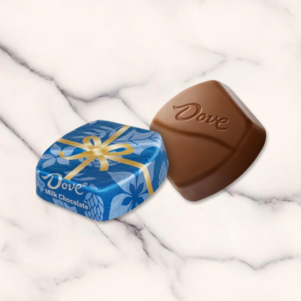 Shows the Dove chocolate product both wrapped in its decorative blue packaging with gold ribbon and unwrapped to display the chocolate piece with embossed branding, giving shoppers a clear view of…