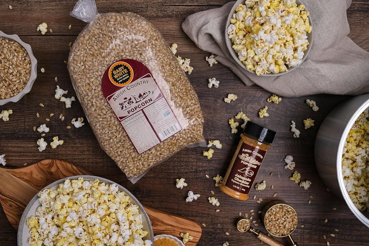 Shows everything included in the purchase: popcorn kernels and seasoning, demonstrating the complete kit the customer receives.