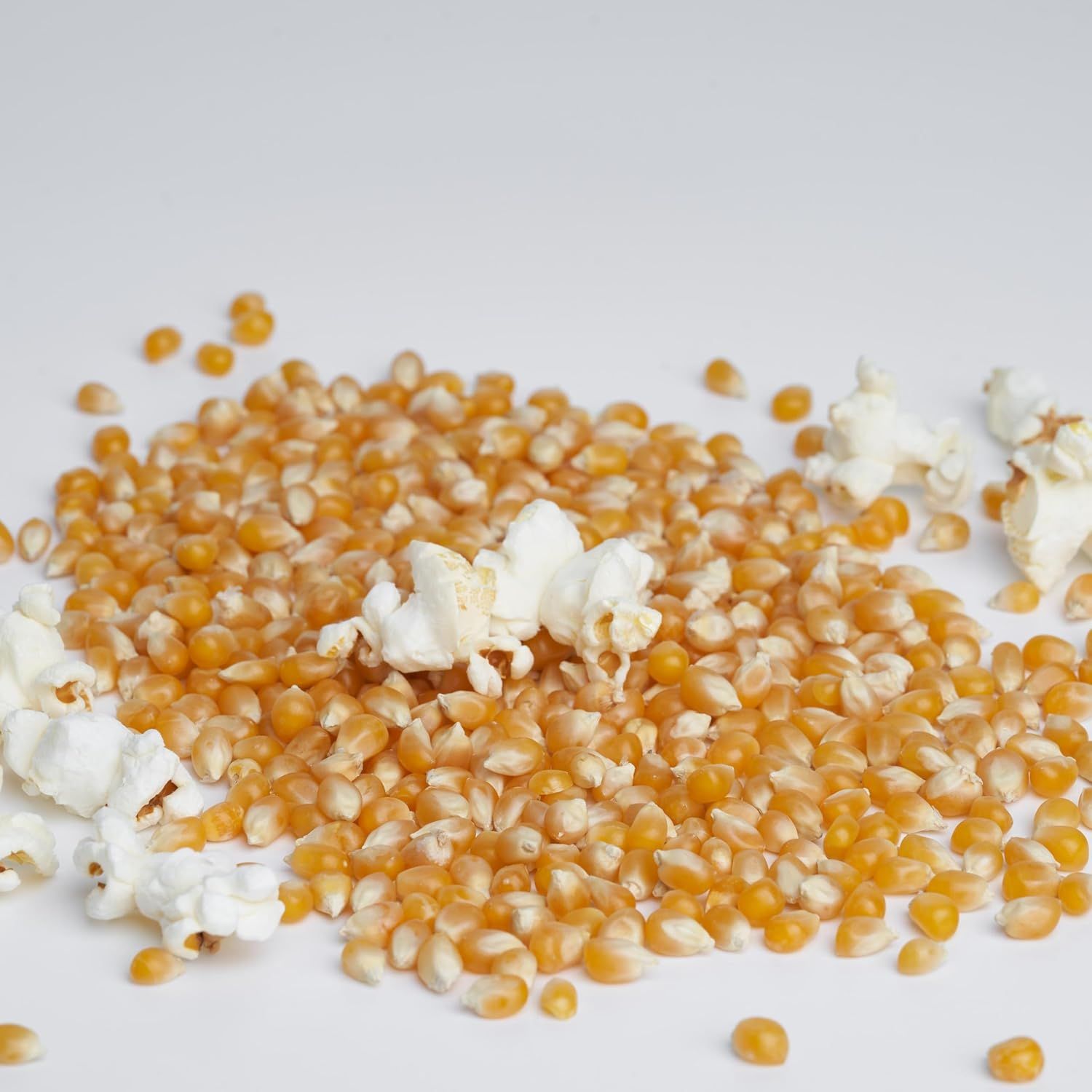 Demonstrates the product's transformation capability, showing unpopped kernels alongside fully popped popcorn to illustrate the end result and quality of the…
