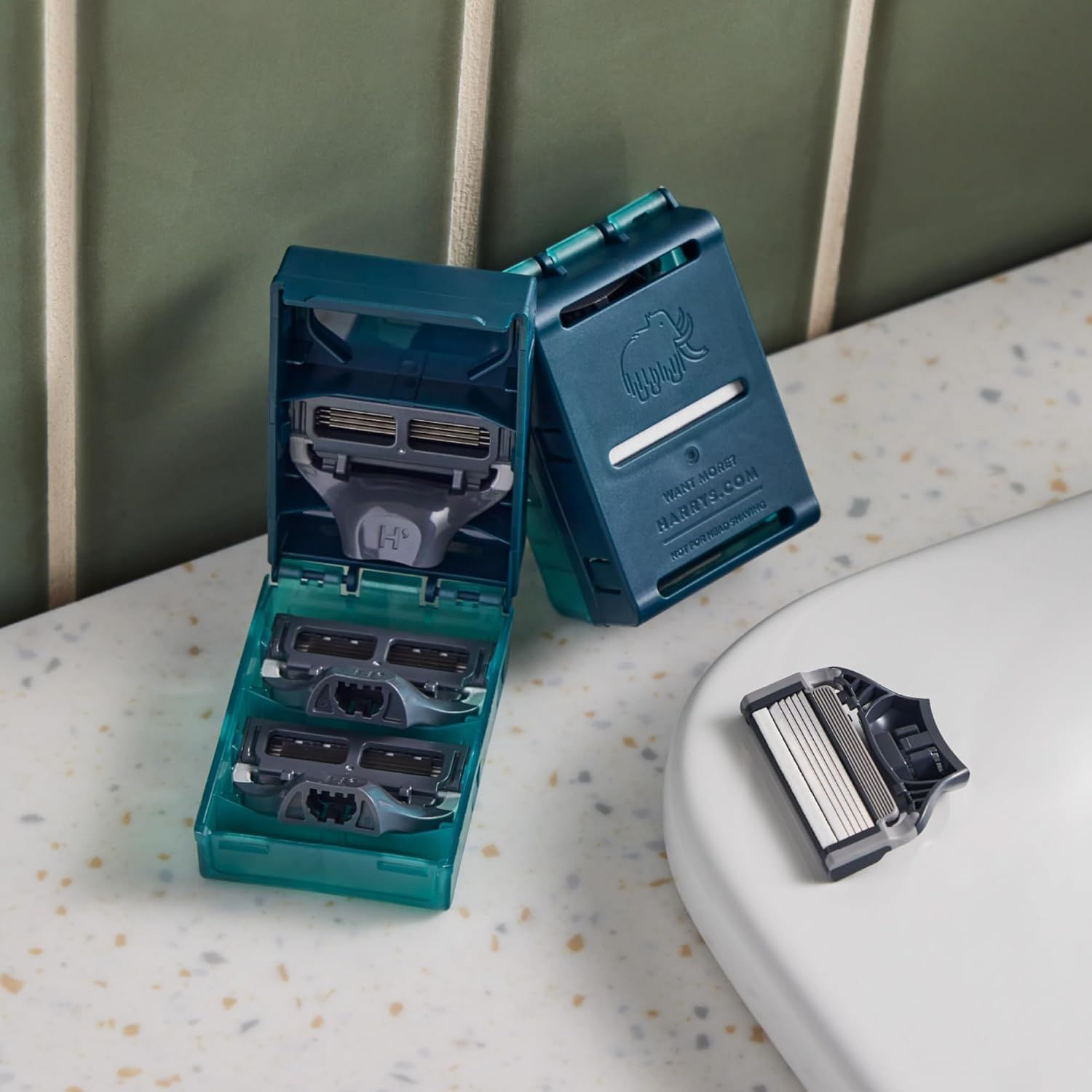 Shows the customer everything included in the purchase: a storage case with multiple razor cartridges and a razor handle, demonstrating the complete kit and value of the bundle.