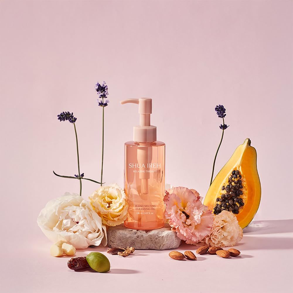 Creates an aspirational, natural beauty aesthetic by showcasing the cleansing oil surrounded by botanical ingredients like flowers, papaya, and nuts to communicate the product's natural formulation…