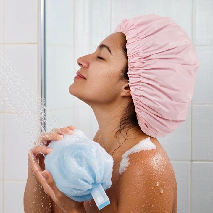 Demonstrates the product in a real-world bathroom setting to help shoppers visualize how the shower cap is used during bathing, creating an emotional connection and showing practical application.