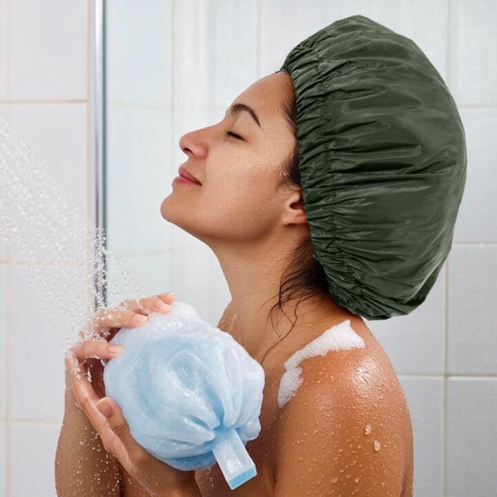 Demonstrates the product being used in a real-world shower setting to show shoppers how the shower cap protects hair during bathing.
