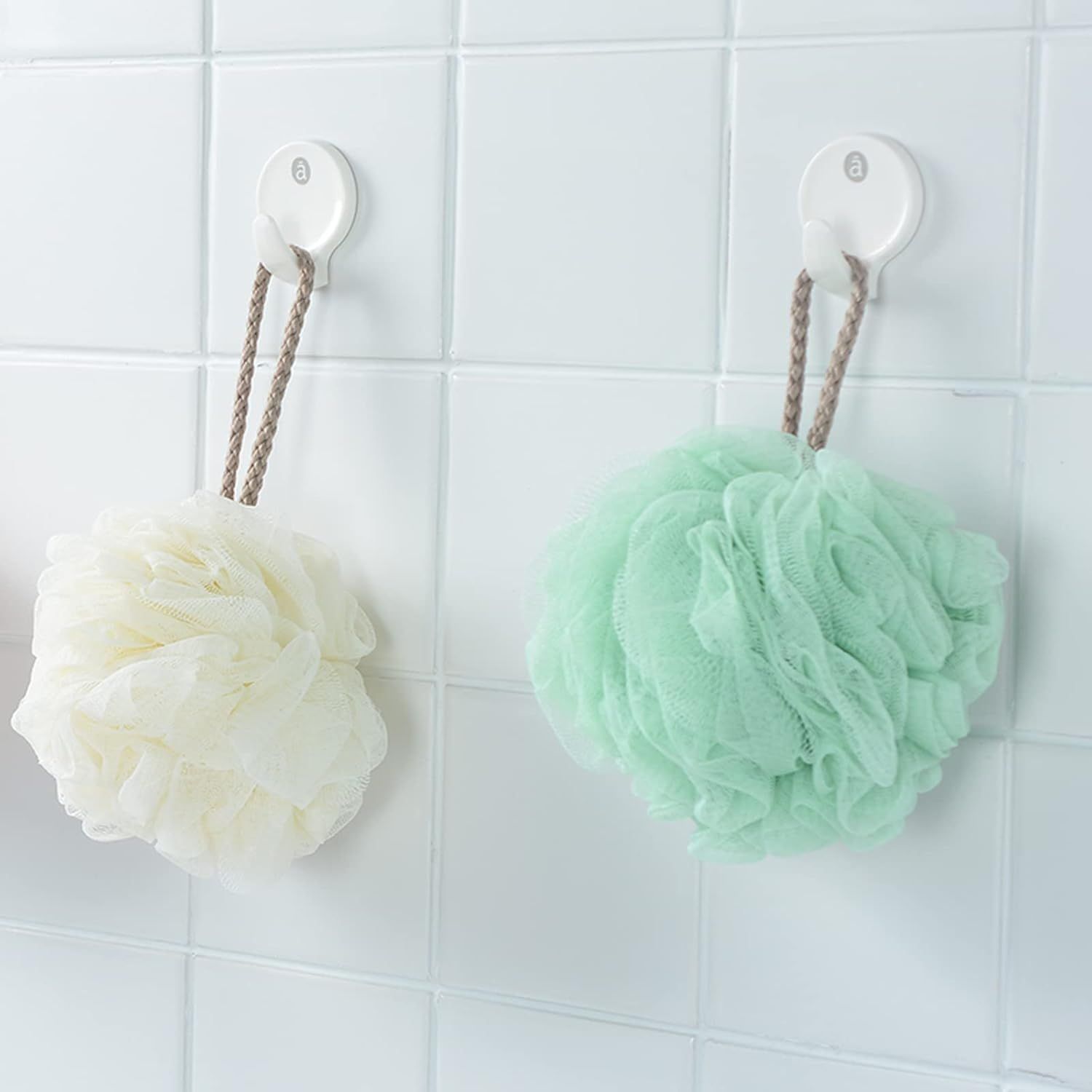 Demonstrates the product in a real-world bathroom setting, showing how the adhesive hooks can be used to hang bath accessories like loofahs, creating a clean and organized space.