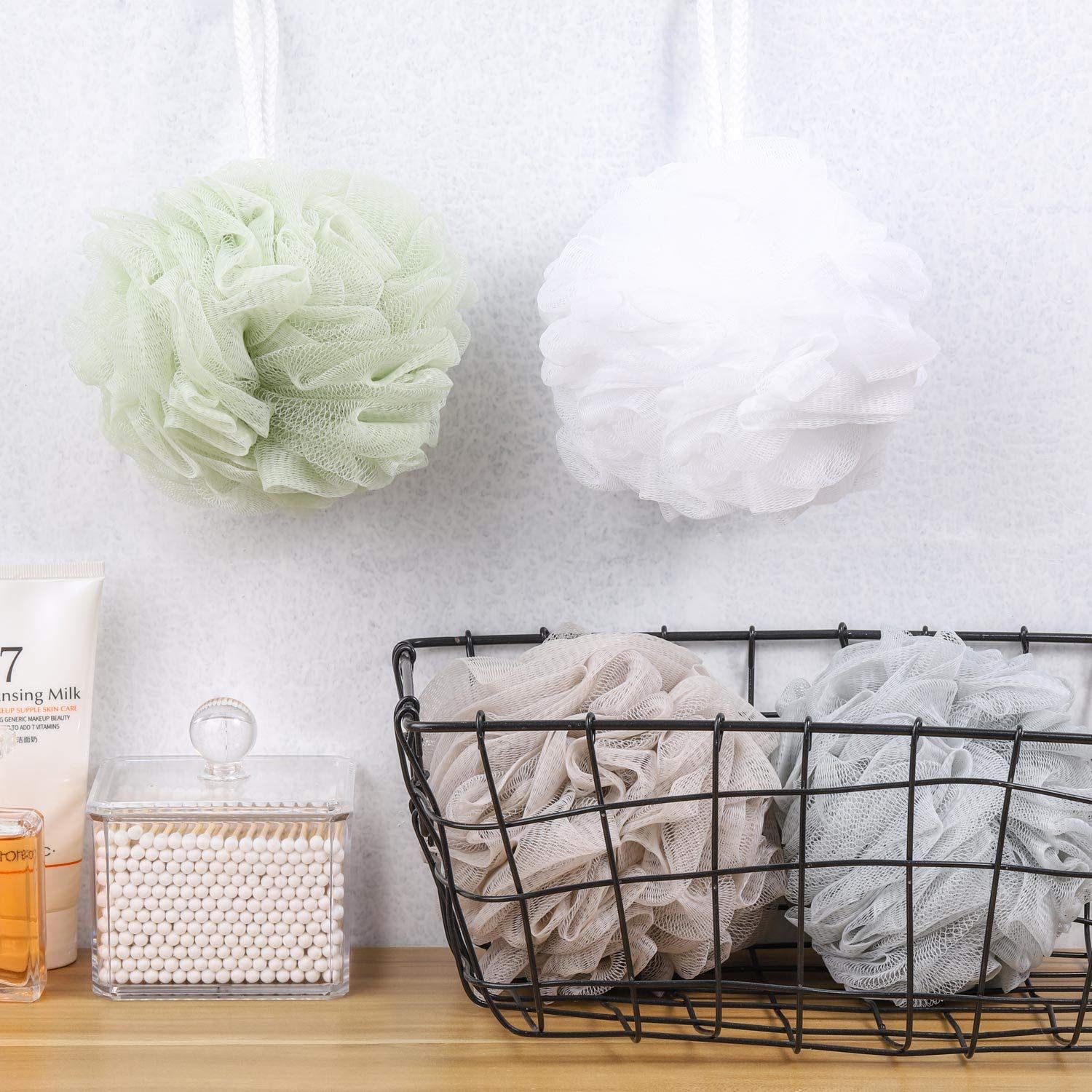 Showcases the bath sponges/loofahs in a real-world bathroom setting to help shoppers visualize how the product looks and can be stored in their own home.